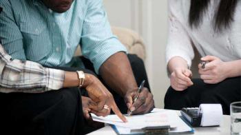 A man signs a lease agreement.